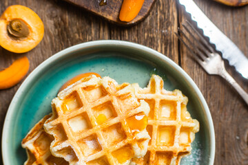 Cottage cheese wafers with apricots and honey in a bowl