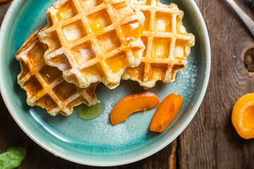 Cottage cheese wafers with apricots and honey in a bowl