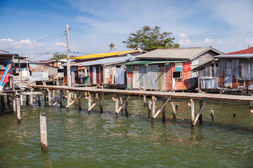 Wooden rickety houses and footbridges on stilts, coastal view