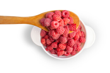 Pour fresh berries with a wooden spoon into a white bowl. Isolated on transparent background.