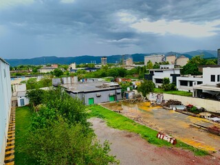 Fototapeta na wymiar Pakistan capital Islamabad city view with urban skyline and clouds in blue sky, City View Point, high rise buildings, City views, green city, Beautiful aerial view of Islamabad.