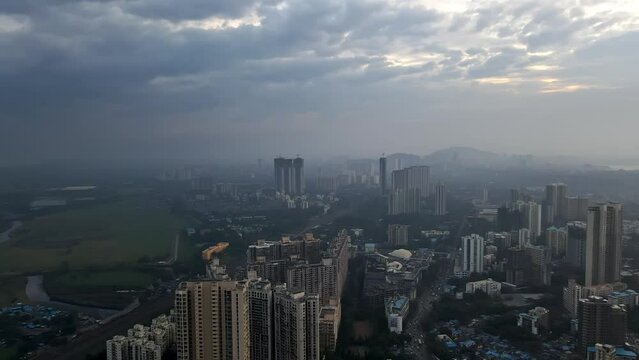 Aerial view of dramatic clouds over the suburban Mumbai, 4k drone of stormy clouds over Indian city. Weather in Mumbai during monsoon. Dramatic dark clouds over Indian city. Climate change in Asian ci