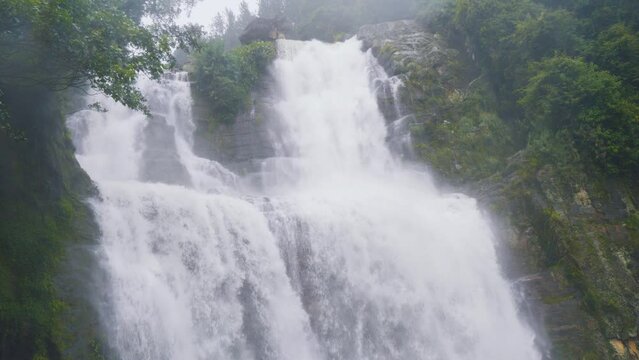 Ramboda Falls. Sri Lanka. Powerful stream of water in rocky mountains.