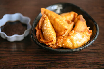 Plate of fried jiaozi or  gyoza with dipping-sauce in Japan.