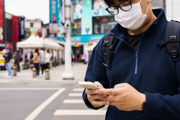 Man in downtown city street ordering taxi using smart phone app Booking taxi using application online on smart phone
