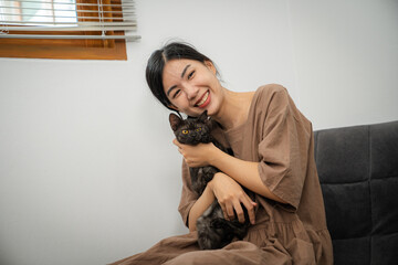 Fototapeta premium Cat lover female hand petting her lovely cat comfortable Stay home with cat&nbsp;Friendship Animal lover. Cute cat. love Friend human home friendship Animal lover lifestyle concept