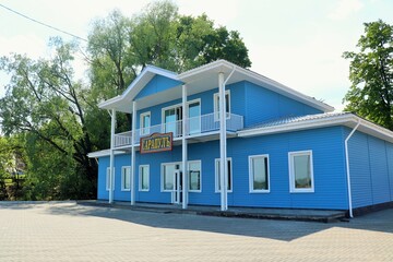 Fototapeta na wymiar Wooden blue building of the river port on the Kama River in the city of Sarapul 