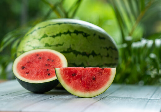 sliced Watermelon on a wooden table with copy pace for text, fresh fruits background