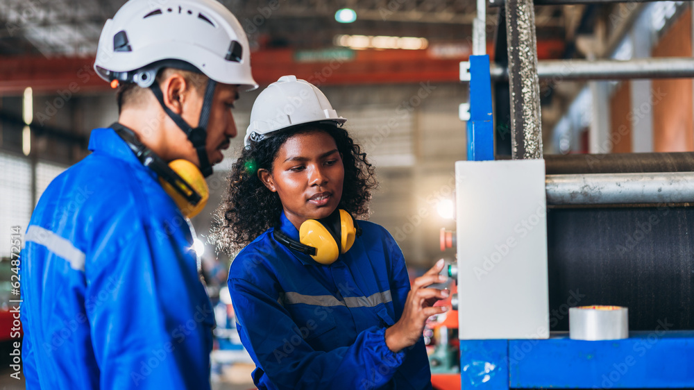 Wall mural Industrial worker inspecting and check up machine at factory machines. Technician working in metal sheet at industry. Foreman checking Material or Machine.