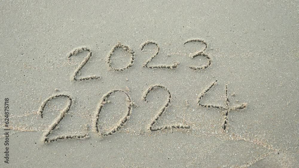 Wall mural message year 2023 replaced by 2024 written on beach sand background. goodbye 2023 hello to 2024 lapp