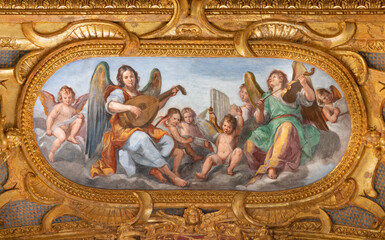Fototapeta na wymiar GENOVA, ITALY - MARCH 5, 2023: The fresco of angels choir with the music instrumenst in the church Chiesa del Gesu by Giovanni Carlone from 17. cent.