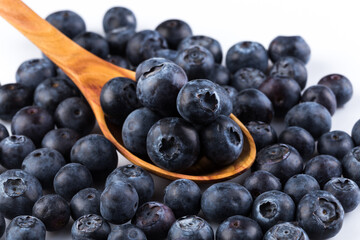 Fresh blueberries in wooden spoon