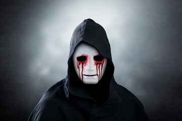 Spooky figure in blood with hooded cape over dark misty background