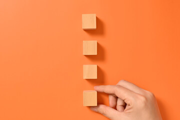 Hand with wooden cubes mock up on abstract background, Copy space, Wooden blocks with copy space for text or symbols, Background with copy space