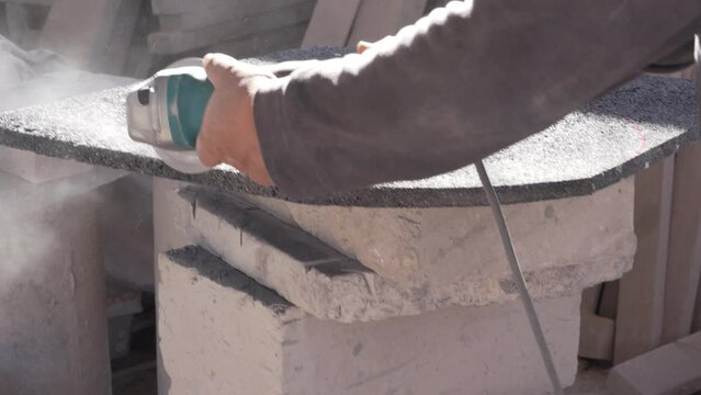 hand saw cut, known as cricket, enclosure stone or natural volcanic stone to create a circle, porous stone powder