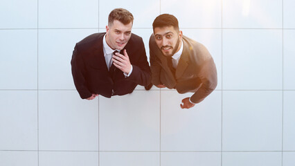 Portrait of two concentrated businessmen partners dressed in formal suit