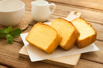 Slices of butter cakes with small white jar.