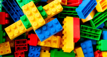 Naklejka premium Large group of plastic toy blocks for background