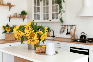 Vase with beautiful yellow sunflowers in the kitchen