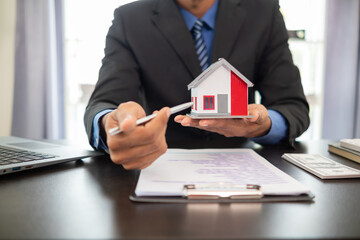 Fototapeta premium Real estate agents are offering sample homes to customers to choose the right home within their real estate office. The concept of buying a home from a reliable real estate agent