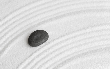 Fototapeta na wymiar Zen Garden with Grey stone on White Sand Wave Pattern in Japanese stye, Rock Sea Stone on Sand texture with the wave parallel lines pattern,Harmony,Meditation,Zen like concept.