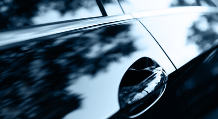 The sunset is reflected  on black new car
