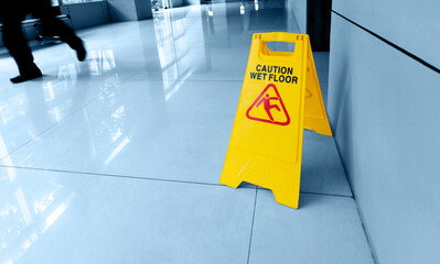 Cleaning and caution wet flooring signboard on the floor - obrazy, fototapety, plakaty
