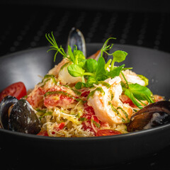 shrimp salad in a black bowl