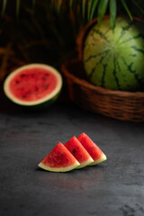 Sliced watermelon on a dark background
