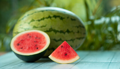 sliced Watermelon on a wooden table with copy pace for text, fresh fruits background