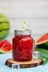 Watermelon smoothies in mason jar with ice cubes