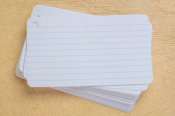 stack of blank index cards against textured bark paper