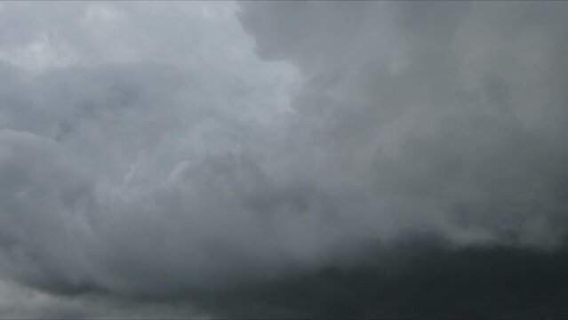 Abstract sky background with moving gray clouds on rainy day - timelapse. Topics: weather, meteorology, space, wind, air, atmosphere, spring, season.