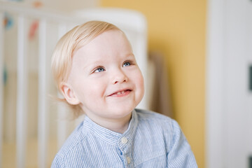 Portrait of cute happy child close-up of smiley face little kid 2 year old. Pretty little boy at home