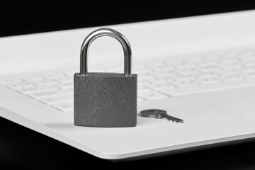 Padlock with a key on a laptop as a concept of protecting information in cyberspace