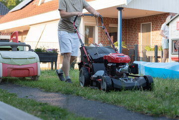 woman mowing lawn in garden