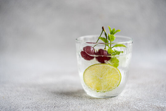 Glass of fresh lime mint and cherry