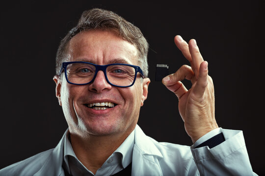 Boisterously laughing, memory card in hand