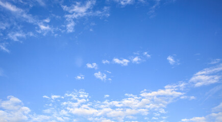 Naklejka na ściany i meble Look up on the blue sky and white clouds background.