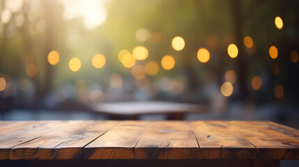 Empty wooden table and bokeh lights blurred outdoor cafe background