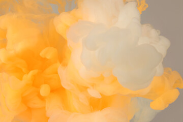 Abstract smoke background. Ink colors blot in water. Yellow, white, beige tone.