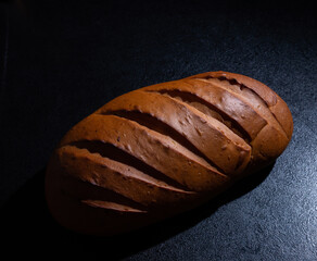 Fresh bread on a black background close-up