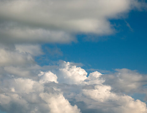 White and grey cumulus clouds background over the blue summer sky background