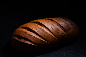 Fresh bread on a black background close-up
