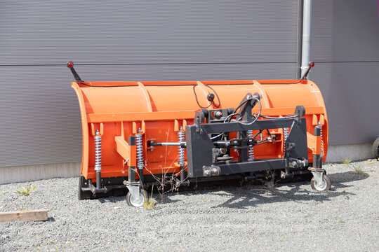 New orange shovel snow plow blade truck, modern municipal machinery