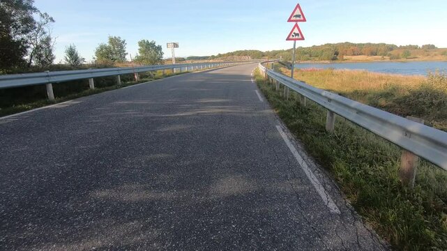 Narrow, traffic-free road, sea left and right, summer, Kystriksveien, RV 17, Heroey, Helgeland, Norway, Europe