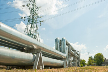 pipeline and power lines against the background of blue sky and clouds