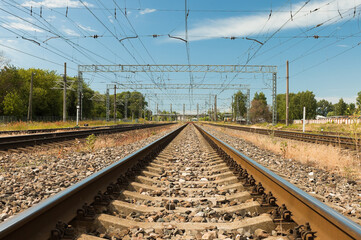 railway, in the photo rails against the background of a blue sky and clouds