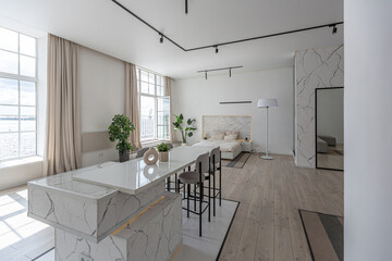 minimalistic modern luxury design of an expensive house with marble trim on a sunny day. white walls with plaster, parquet, decorative lighting and no one inside