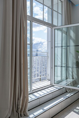 Fototapeta premium minimalistic modern luxury design of an expensive house with marble trim on a sunny day. white walls with plaster, parquet, decorative lighting and no one inside